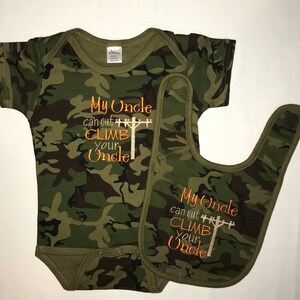 May include: Camouflage baby bodysuit and bib set with the text "My Uncle can out CLIMB your Uncle" embroidered in orange on both pieces.