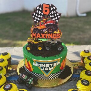 Puede incluir: Un pastel verde decorado con el tema Monster Jam. El pastel presenta un adorno con un cami&oacute;n monstruo, banderas a cuadros y el n&uacute;mero 5. El pastel est&aacute; decorado con camiones monstruo de juguete y las palabras "Monster Jam".