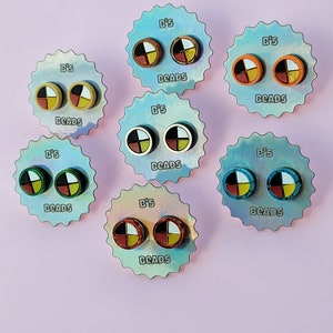 May include: Six pairs of colorful earrings with a Native American design. Each pair is displayed on a card with the words "B's Beads" printed on it.