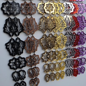 May include: A collection of decorative earrings in various colors and designs. The earrings are made of wood and metal, featuring floral and geometric shapes. Colors include black, brown, gold, silver, red, and purple. The earrings are displayed on a white background.
