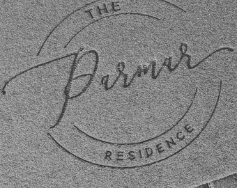 May include: A black and white image of a circular logo with the text "THE REMARKABLE RESIDENCE" in a stylized font.