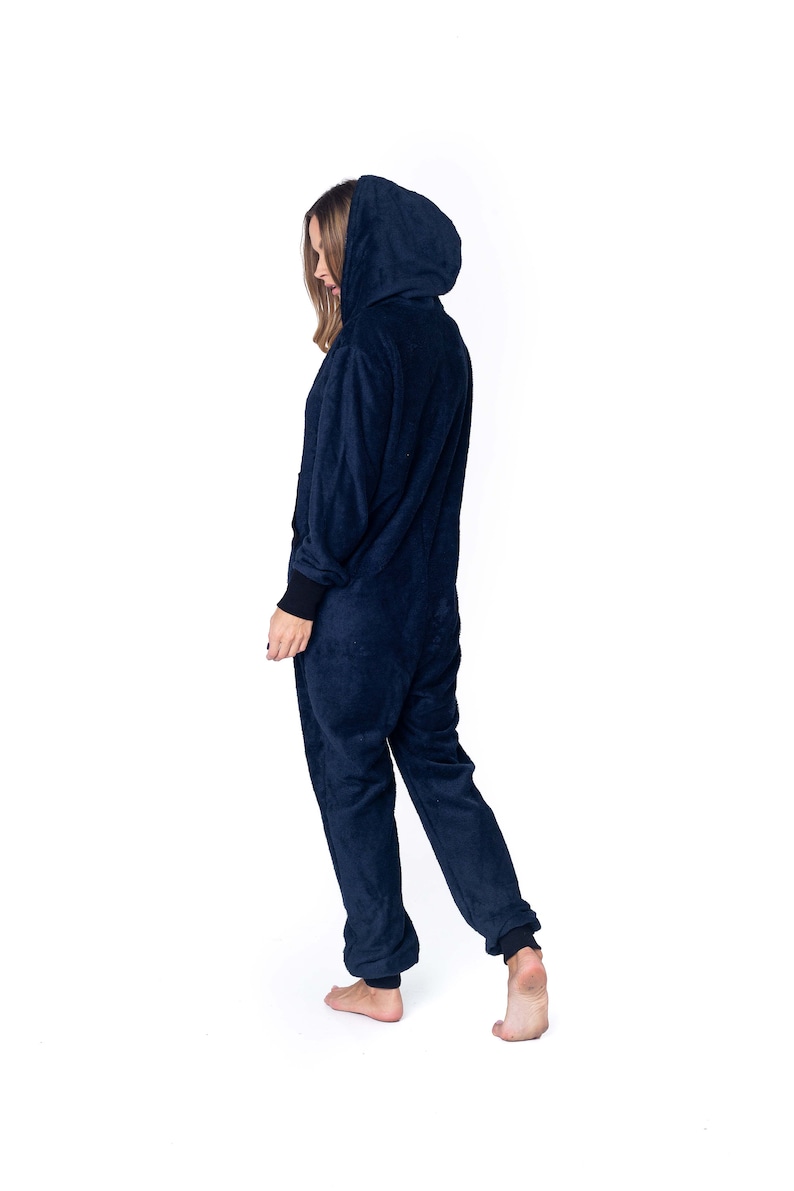 May include: A navy blue hooded onesie with long sleeves and a zipper closure. The onesie is made of a soft, plush fabric.