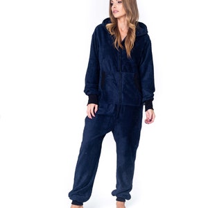 May include: A navy blue hooded jumpsuit with a zipper closure. The jumpsuit is made of a soft, fuzzy material.