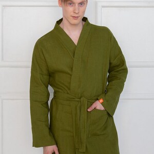 May include: A long-sleeved, olive green robe with a self-tie belt and a patch pocket on the left side.