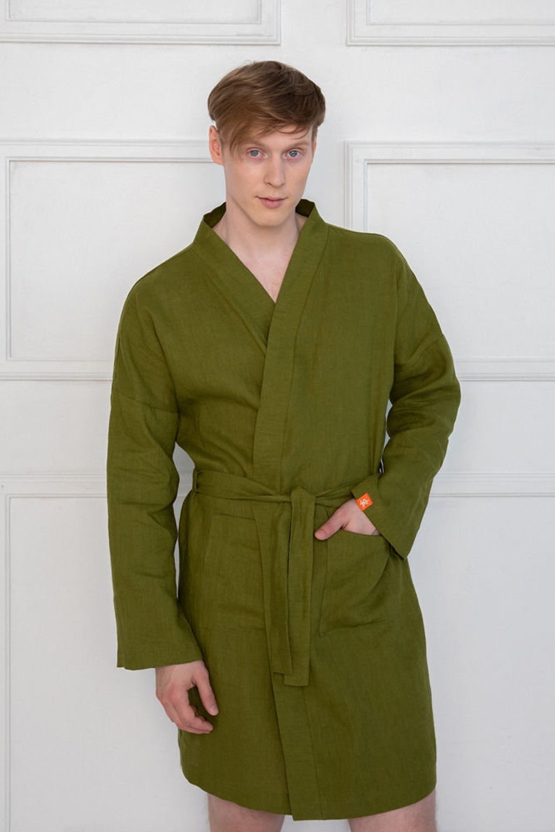 May include: A long-sleeved, olive green robe with a self-tie belt and a patch pocket on the left side.