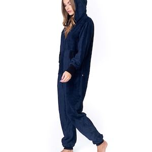 May include: A navy blue hooded jumpsuit with a zipper closure. The jumpsuit has a soft, fuzzy texture.