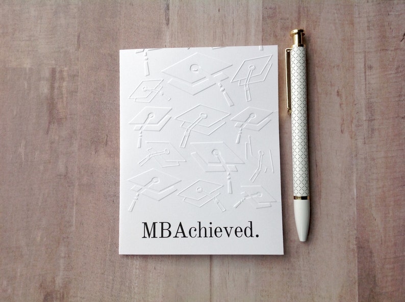 May include: White card with a pattern of graduation caps and the text "MBA Achieved."
