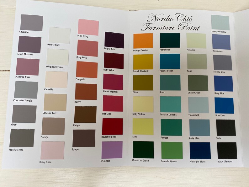 May include: A color chart of paint colors for furniture. The chart is divided into rows and columns, with each color having a name. The colors include lavender, lilac blossom, mamma rosa, concrete jungle, grey, maskat nut, baby rose, nordic chic, whipped cream, camellia, cafe au lait, sandy, taupe, pink icing, rosy peony, pumpkin, mam's lipstick, rusty, fudge, ravishing red, wioletta, purple rain, orange passion, petronella, pistachio, lovely blushing, french mustard, pacific ocean, sage, stormy grey, olive, aster, dusty green, deep blue, silky yellow, turkish delight, tinkerbell, blue eyes, lime, forest, baby blue, slate, moroccan green, emerald queen, midnight blues, and black diamond.