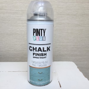 May include: A can of Pinty Plus Chalk Finish spray paint in turquoise. The white can has black and turquoise text, and a clear plastic cap. The label shows a turquoise cabinet illustration.