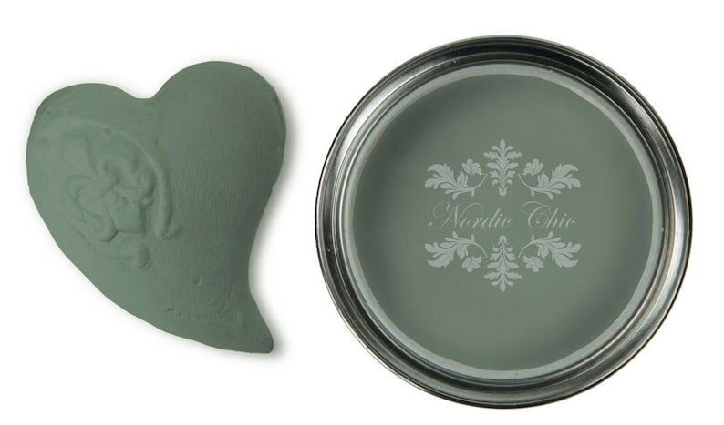 May include: A small sample of green paint in a heart shape and a can of green paint with the text "Nordic Chic" on the label.