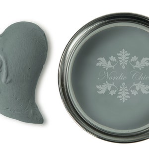 May include: A sample of light blue paint in a heart-shaped container and a paint can with the text "Nordic Chic" on the label.