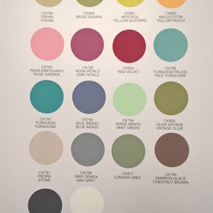 May include: A colour chart for Pinty Plus Chalk Paint Spray, showcasing various shades. The chart presents circular paint samples with names such as "Cream", "Rose Garden", and "Blue Indigo".