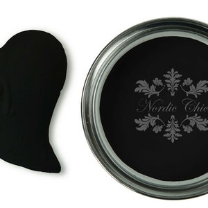 May include: A black paint sample in a heart shape and a can of black paint with the text "Nordic Chic" on the label.