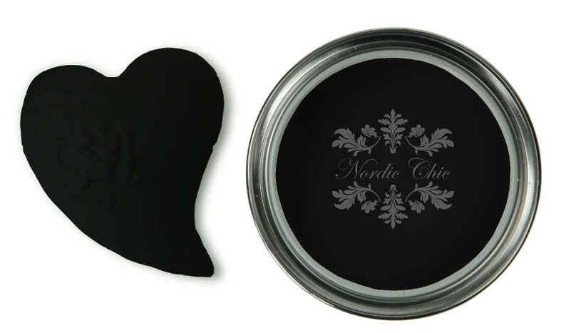 May include: A black paint sample in a heart shape and a can of black paint with the text "Nordic Chic" on the label.