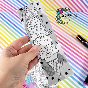 May include: A black and white illustration of a tall ice cream cone with three scoops of ice cream, sprinkles, and a cherry on top. The image is on a white card with a black and white dotted pattern and stars.