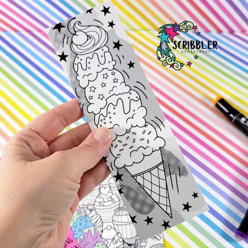 May include: A black and white illustration of a tall ice cream cone with three scoops of ice cream, sprinkles, and a cherry on top. The image is on a white card with a black and white dotted pattern and stars.