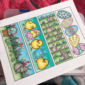 May include: A set of four colorful bookmarks featuring Easter-themed illustrations. The bookmarks depict chicks, bunnies, and eggs with intricate designs. Each bookmark is approximately 10 cm in length.