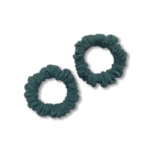 May include: Two teal blue scrunchies made of soft, stretchy fabric. The scrunchies are in a coiled shape and are perfect for holding hair.
