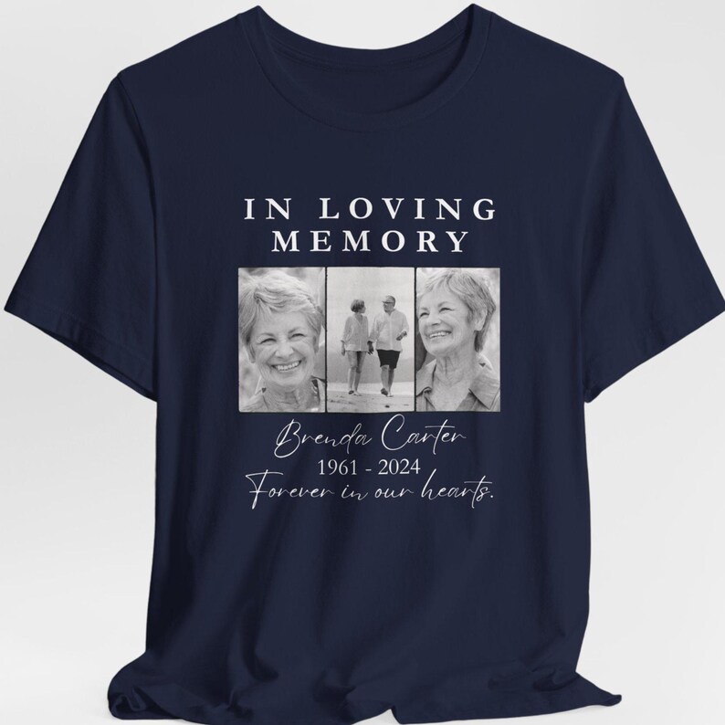 May include: Navy blue t-shirt with the text "IN LOVING MEMORY" above three black and white photos. Below the photos is the name "Brenda Carter" with the years "1961-2024" and the phrase "Forever in our hearts."