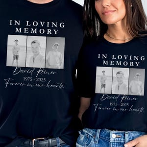 May include: Black t-shirts with a memorial design. Each shirt features the text "IN LOVING MEMORY" above a series of three black and white photos. Below the photos is the name "David Reiner" and the years "1975-2025", with the phrase "Forever in our hearts."