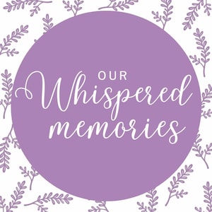May include: A circular design with the words "Our Whispered Memories" in white script on a lavender background. The background features a repeating pattern of lavender sprigs on a white surface.