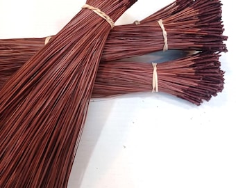 May include: Three bundles of long, thin, reddish-brown pine needles, each tied securely in the center with a light-colored natural fiber string. The needles are straight, uniform in length, and have dark, pointed tips, arranged in a fan-like cluster.