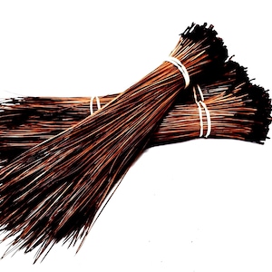 May include: Two bundles of brown and black floral wire, secured with white rubber bands. The wire is thin and appears to be made of metal. The bundles are arranged on a white background.