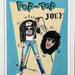 May include: A framed art print titled POP-TOP JOEY featuring a headless figure in a black leather jacket, white Mickey Mouse Club t-shirt, and distressed blue jeans holding a microphone. A detached head with dark hair and sunglasses floats nearby.