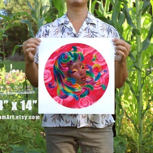 May include: A square art print, 14 x 14 inches, featuring a vibrant illustration of a face with colorful hair and a red background. The artwork has a circular design with the text "BaoPhamArt.etsy.com" at the bottom.