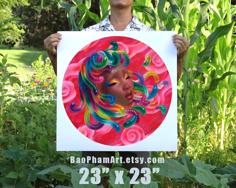 May include: A square art print featuring a portrait of a woman with colorful, serpentine hair. The artwork is set against a red background with pink roses. The print measures 23 inches by 23 inches.