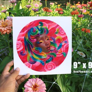 May include: A square print, 9" x 9", featuring a portrait of a woman with rainbow-colored hair and a red background. The artwork is a colorful illustration with the artist's Etsy shop URL in the bottom right corner.