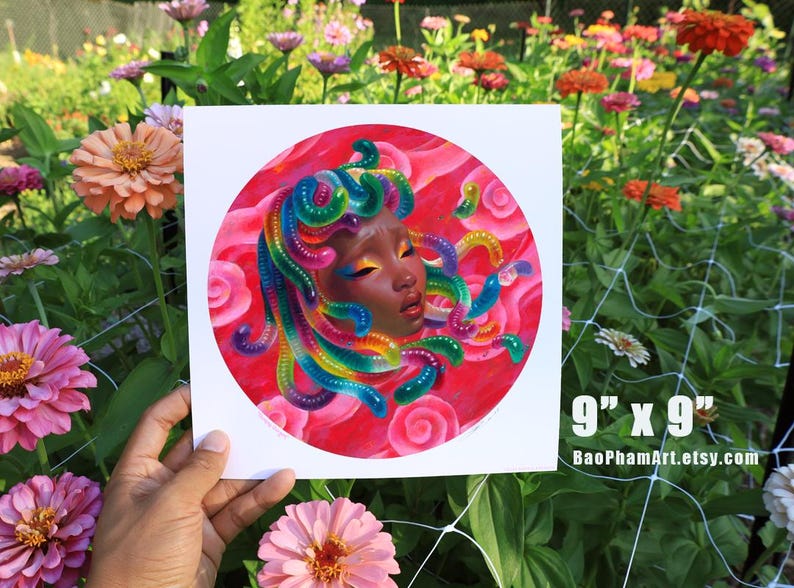 May include: A square print, 9" x 9", featuring a portrait of a woman with rainbow-colored hair and a red background. The artwork is a colorful illustration with the artist's Etsy shop URL in the bottom right corner.