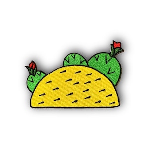May include: A yellow embroidered taco with green cactus plants and red flowers on top.