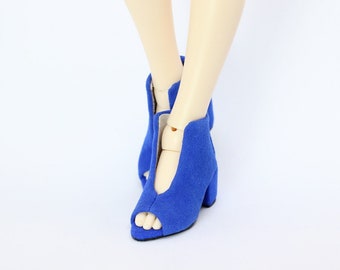May include: A pair of blue peep-toe heeled shoes with a pointed toe and a chunky heel.