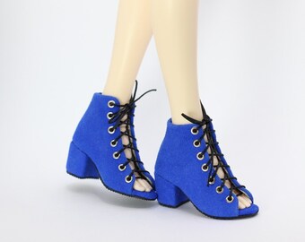 May include: Blue suede ankle boots with black laces and a peep toe. The boots have a block heel.