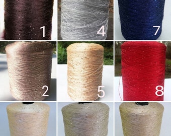 May include: Nine spools of thread with sequins, in various colors, including brown, beige, gray, gold, red, and blue. The spools are numbered 1 through 9.