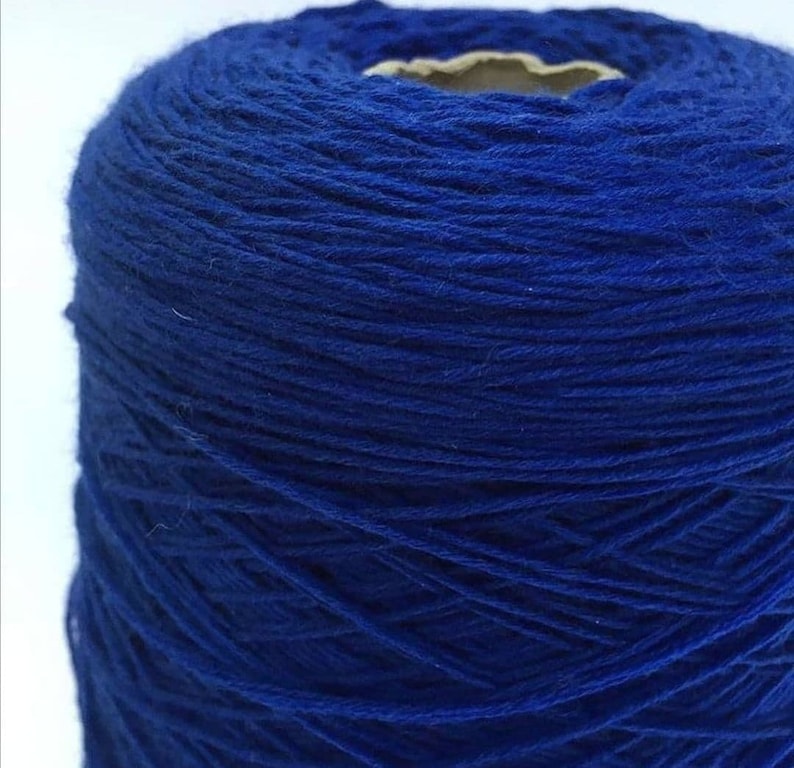 May include: A spool of bright blue yarn.