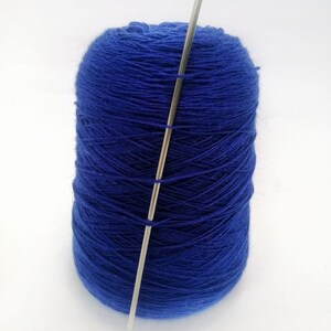 May include: A ball of blue yarn with a silver knitting needle sticking through the center.