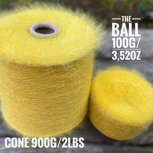 May include: A yellow ball of yarn with a fuzzy texture. The ball weighs 3.52 ounces and is part of a larger cone that weighs 2 pounds.