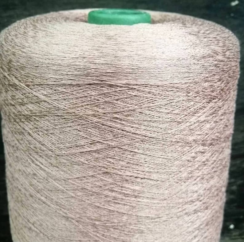 May include: A spool of light brown yarn wound tightly.