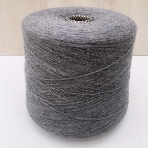 May include: A spool of gray yarn.