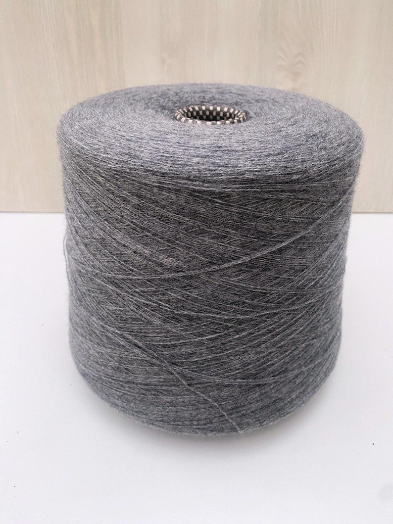 May include: A spool of gray yarn.