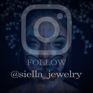 May include: A dark blue image featuring a woman's face with a butterfly over her mouth. The Instagram logo is overlaid, with the word "FOLLOW" and the username "@siella_jewelry" in white text. The background has white floral accents.