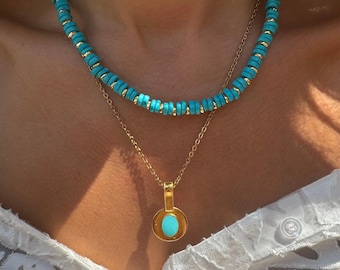 May include: A gold chain necklace with a turquoise pendant and a turquoise beaded necklace.