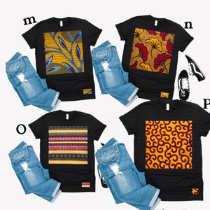 May include: Four black t-shirts with different colourful patterned designs. The designs are geometric, floral, and abstract. The shirts are laid out on a white background with blue jeans and a pair of black trainers.