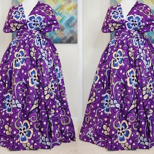 May include: A purple maxi dress with a floral print and a V-neckline. The dress has a wrap-style bodice and a flowing skirt.