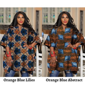 May include: Two women wearing long, loose-fitting shirts with different patterns. The shirt on the left has a blue and orange floral pattern, while the shirt on the right has a blue and orange geometric pattern. Both shirts have a V-neck and are worn with blue jeans. The text "Orange Blue Lilies" is below the woman on the left, and the text "Orange Blue Abstract" is below the woman on the right.