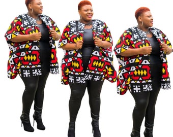 May include: Three women wearing black leggings and black heeled boots. Each woman is wearing a red, yellow, white, and black patterned kimono-style jacket.
