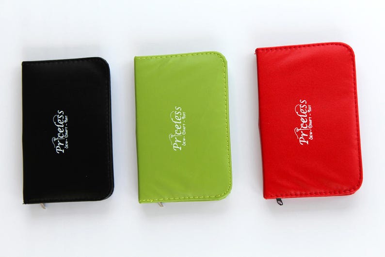 May include: Three card holders in different colours with the word "priceless" printed on them. The card holders are black, green and red.