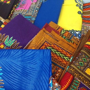 May include: A collection of colorful fabric with various patterns, including geometric designs, floral motifs, and stripes. The fabrics are arranged in a layered and overlapping fashion, creating a visually appealing and textured display.
